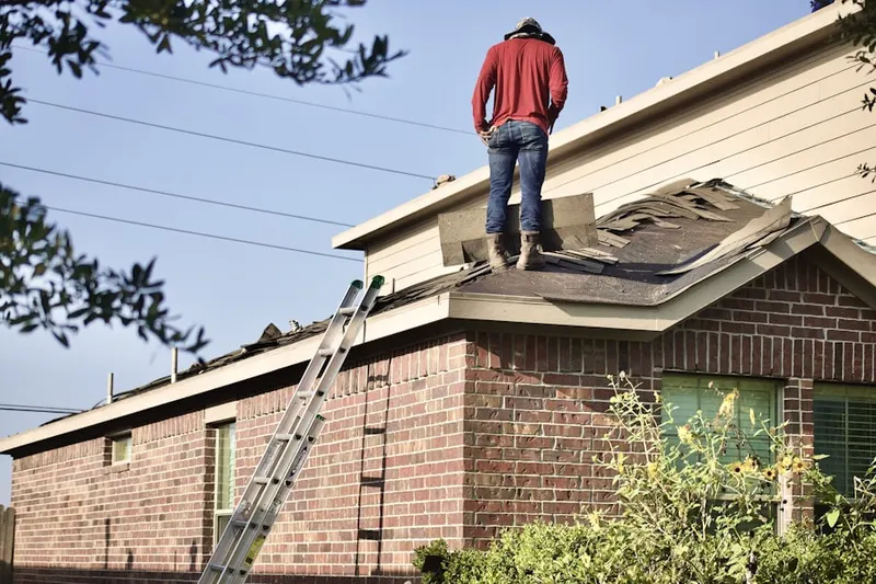 Professional roofer working on a residential roof in Oliver